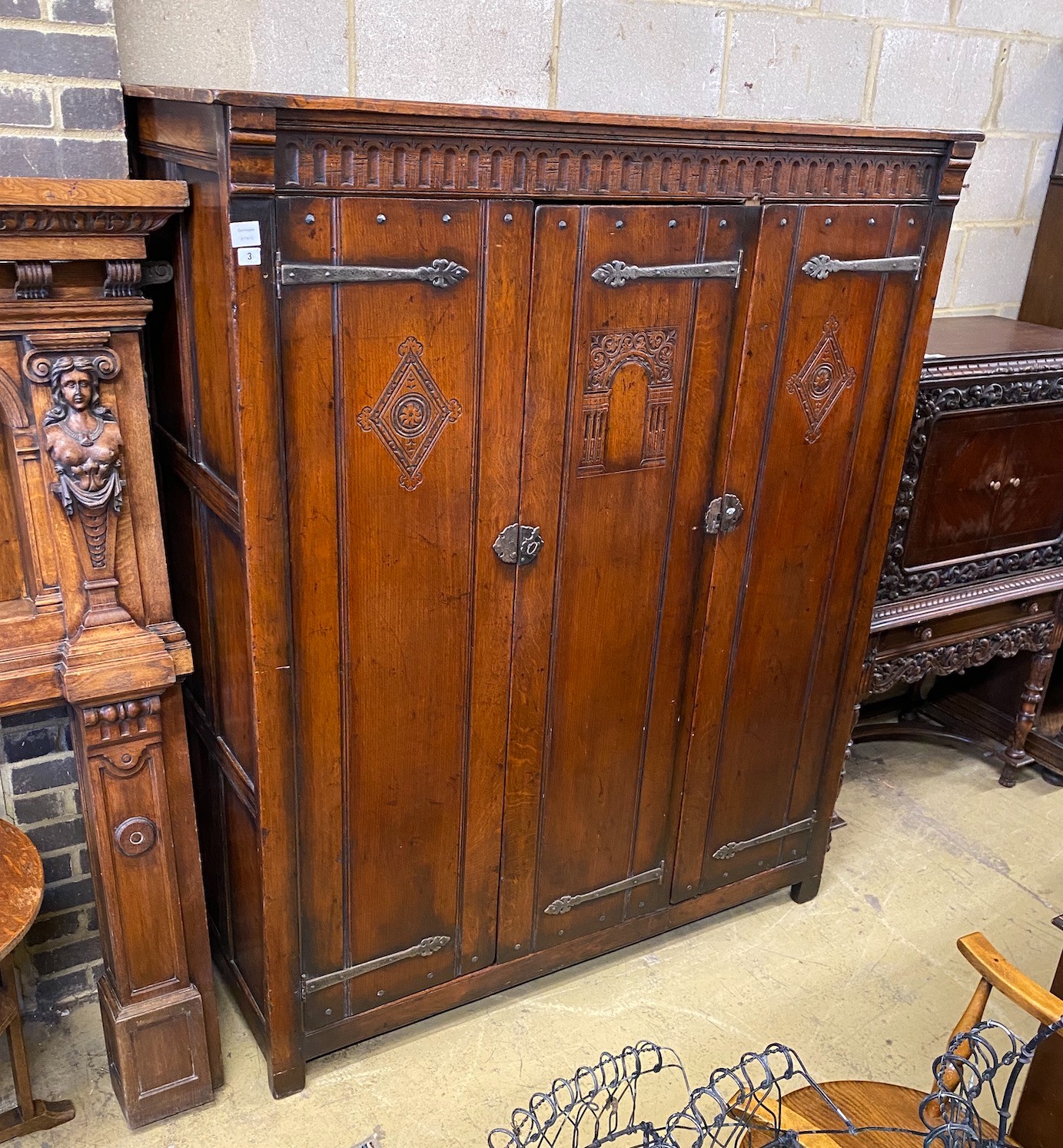 A 17th century style oak three door wardrobe, width 150cm, depth 61cm, height 183cm